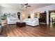 Bright living room with hardwood floors, neutral sofas, and a ceiling fan at 301 East Highway 5, Roopville, GA 30170