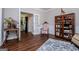Cozy living space featuring hardwood floors, a decorative rug, and a view of a stylish cabinet and bookshelf at 301 East Highway 5, Roopville, GA 30170