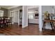 Open-concept living space with hardwood floors, seamlessly connecting the dining area and a cozy living room with a fireplace at 301 East Highway 5, Roopville, GA 30170