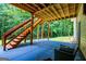 Covered patio with concrete flooring, steps leading to the backyard and surrounding greenery providing a private retreat at 301 East Highway 5, Roopville, GA 30170