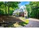 Picturesque home with brick accents, attached garage, and a covered front porch, nestled in a serene setting at 301 East Highway 5, Roopville, GA 30170