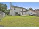 The backyard has a well-manicured lawn with a fenced perimeter and a two-story house in the background at 1255 Silverstone Trl, Jonesboro, GA 30238