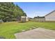 Spacious backyard featuring lush grass, mature trees, a trampoline, and plenty of space for outdoor activities at 1255 Silverstone Trl, Jonesboro, GA 30238