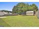 Spacious backyard featuring a well-kept lawn and a storage shed, perfect for outdoor activities at 1255 Silverstone Trl, Jonesboro, GA 30238