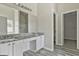 Bathroom featuring double vanity, granite countertops, and modern fixtures plus a walk-in closet at 1255 Silverstone Trl, Jonesboro, GA 30238