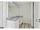 Bathroom with double vanity, granite countertops, modern lighting, and wood-look flooring at 1255 Silverstone Trl, Jonesboro, GA 30238