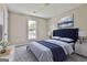 Cozy bedroom with a plush bed, serene artwork, and soft natural light from the window at 1255 Silverstone Trl, Jonesboro, GA 30238