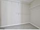 Spacious walk-in closet with carpeted floor and shelving for ample storage at 1255 Silverstone Trl, Jonesboro, GA 30238