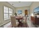 Dining room featuring modern floors, a round table, and an adjacent kitchen at 1255 Silverstone Trl, Jonesboro, GA 30238