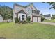 Two-story home featuring a two-car garage, a bay window, and a lush front lawn at 1255 Silverstone Trl, Jonesboro, GA 30238
