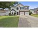 Two-story home with a well-maintained lawn, a two-car garage and bay window for curb appeal at 1255 Silverstone Trl, Jonesboro, GA 30238