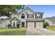 Two-story home with manicured lawn, brick accents, two-car garage, and black shutters at 1255 Silverstone Trl, Jonesboro, GA 30238