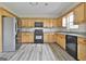Functional kitchen featuring wood cabinets and stainless steel appliances at 1255 Silverstone Trl, Jonesboro, GA 30238