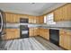 A spacious kitchen featuring wood cabinets, granite countertops, and modern appliances at 1255 Silverstone Trl, Jonesboro, GA 30238