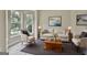 Staged living room with neutral tones, large windows, and stylish furniture at 1255 Silverstone Trl, Jonesboro, GA 30238