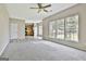 Open concept living room with a carpeted fireplace area at 1255 Silverstone Trl, Jonesboro, GA 30238