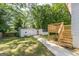 Spacious backyard featuring a wooden deck, storage building, and lush green lawn at 1446 Westmont Sw Rd, Atlanta, GA 30311