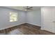 This light-blue bedroom features wood-look floors, a ceiling fan, and natural light through windows at 1446 Westmont Sw Rd, Atlanta, GA 30311