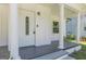 Charming entrance with tiled porch, white pillars, and a decorative glass front door at 1446 Westmont Sw Rd, Atlanta, GA 30311