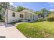 Charming renovated home featuring white exterior, inviting front porch, and lush lawn at 1446 Westmont Sw Rd, Atlanta, GA 30311