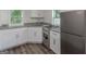 Well-lit kitchen with stainless steel appliances, white cabinets and granite countertops at 1446 Westmont Sw Rd, Atlanta, GA 30311