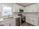 Modern kitchen design featuring stainless appliances and a white backsplash at 1446 Westmont Sw Rd, Atlanta, GA 30311
