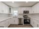 Stylish new kitchen with stainless steel appliances, white cabinets and backsplash at 1446 Westmont Sw Rd, Atlanta, GA 30311
