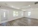 Open concept living room with front door view, hardwood flooring and many windows at 1446 Westmont Sw Rd, Atlanta, GA 30311