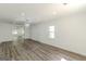 Spacious living room area featuring new flooring, lighting, and neutral walls at 1446 Westmont Sw Rd, Atlanta, GA 30311