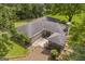 Aerial view of the roof of the home with a screened-in gazebo surrounded by lush greenery at 2164 Old Rex Morrow Rd, Morrow, GA 30260