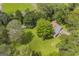 Aerial view showcasing the home's setting amidst lush greenery and nearby athletic field at 2164 Old Rex Morrow Rd, Morrow, GA 30260