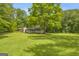 Expansive backyard with mature trees, providing shade and privacy at 2164 Old Rex Morrow Rd, Morrow, GA 30260