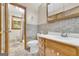 Well-lit bathroom featuring vanity with a tile backsplash, toilet, and walk-in shower at 2164 Old Rex Morrow Rd, Morrow, GA 30260
