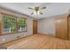 Bright bedroom with hardwood floors, natural light, ceiling fan, and neutral paint at 2164 Old Rex Morrow Rd, Morrow, GA 30260
