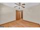 This bedroom features hardwood floors, a ceiling fan, and a closet for storage at 2164 Old Rex Morrow Rd, Morrow, GA 30260