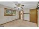 Bright bedroom boasts ceiling fan, natural light from window, and access to hallway and bathroom at 2164 Old Rex Morrow Rd, Morrow, GA 30260