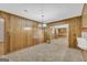 Dining room featuring wood paneling, traditional chandelier, and an inviting open layout at 2164 Old Rex Morrow Rd, Morrow, GA 30260