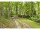 Gravel driveway winding through a lush, wooded area at 2164 Old Rex Morrow Rd, Morrow, GA 30260