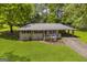 Charming single-story brick home with a well-maintained front yard and covered parking at 2164 Old Rex Morrow Rd, Morrow, GA 30260