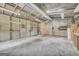 Spacious metal garage with concrete flooring and ample storage space illuminated by fluorescent lights overhead at 2164 Old Rex Morrow Rd, Morrow, GA 30260
