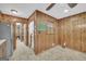 Eat-in kitchen features wood paneling, window and bulletin board; refrigerator visible to left at 2164 Old Rex Morrow Rd, Morrow, GA 30260