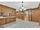 Spacious kitchen with wood paneling, ample counter space, and cozy breakfast bar at 2164 Old Rex Morrow Rd, Morrow, GA 30260