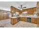 Spacious kitchen features matching wood cabinets, laminate countertop and view into wood-paneled eat-in area at 2164 Old Rex Morrow Rd, Morrow, GA 30260