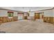 Open living room features carpeted floors, natural light, and access to kitchen and exterior at 2164 Old Rex Morrow Rd, Morrow, GA 30260