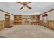 Spacious living room features a stone fireplace, carpeting, and custom built-in shelving at 2164 Old Rex Morrow Rd, Morrow, GA 30260