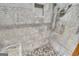 Shower showcasing mosaic tile flooring, built in shower seat, and upgraded fixtures at 2164 Old Rex Morrow Rd, Morrow, GA 30260