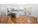 Bright, open kitchen with stainless steel appliances, white cabinets, hardwood floors, and an island with seating at 3859 N Camp Creek Sw Pkwy, Atlanta, GA 30331