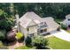 Aerial view of this two-story home showing the roof, manicured lawn, and mature trees at 148 Lakeside Dr, Peachtree City, GA 30269