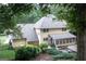Exterior view of the home with a spacious backyard and large deck area at 148 Lakeside Dr, Peachtree City, GA 30269