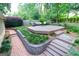 Landscaped backyard with brick steps and spacious deck seating area at 148 Lakeside Dr, Peachtree City, GA 30269